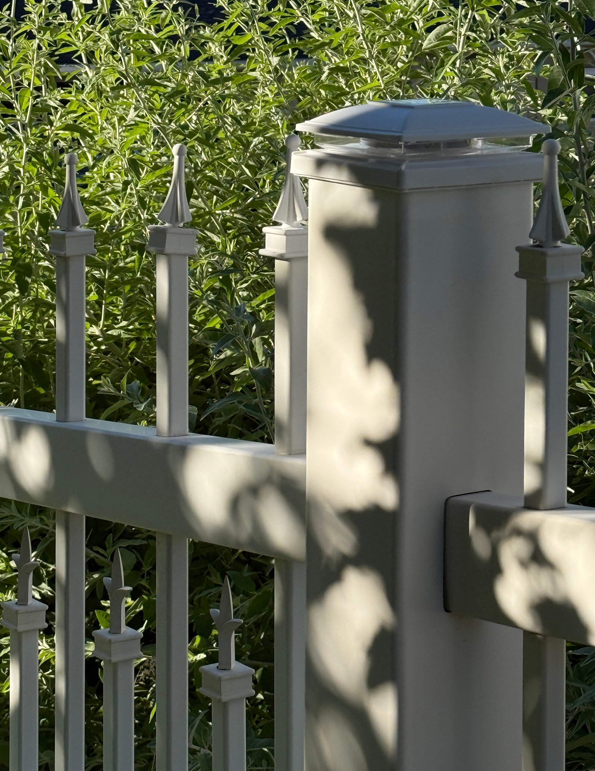 White vinyl fence with solar post light